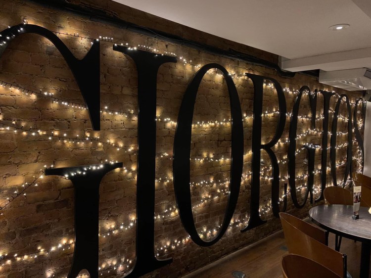 Giorgios sign decorated with fairy lights